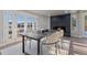 Bright dining area with modern table, chairs, and fireplace near a patio entrance at 11725 Tomahawk Trl, Conifer, CO 80433