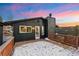 Exterior view of the home on a wooden deck, featuring snowy surroundings at 11725 Tomahawk Trl, Conifer, CO 80433