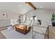 Bright and open living room with beamed ceiling, modern furniture, and lots of natural light at 11725 Tomahawk Trl, Conifer, CO 80433