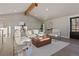 Spacious living room with beamed ceilings, neutral decor, and lots of natural light at 11725 Tomahawk Trl, Conifer, CO 80433
