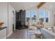 Bright living room features a wood burning fireplace and large windows with mountain views at 11725 Tomahawk Trl, Conifer, CO 80433