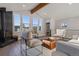 A bright living room with a wood-burning stove and large windows with expansive views at 11725 Tomahawk Trl, Conifer, CO 80433