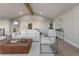 Spacious living room boasts lots of seating, beamed ceilings, and neutral decor at 11725 Tomahawk Trl, Conifer, CO 80433