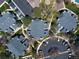 Aerial view of multiple buildings with plentiful parking spaces and mature trees at 4086 S Carson St # F, Aurora, CO 80014