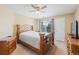 Cozy bedroom features wood furniture, a ceiling fan, and a window with natural light at 4086 S Carson St # F, Aurora, CO 80014