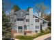 Well-maintained building features siding, a roof with chimneys, and landscaped surroundings at 4086 S Carson St # F, Aurora, CO 80014