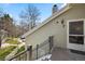Exterior view of the residence featuring siding, a chimney, and an outdoor entryway with stairs and metal railing at 4086 S Carson St # F, Aurora, CO 80014