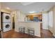 Efficient kitchen layout with stainless appliances, breakfast bar, and adjacent laundry area at 4086 S Carson St # F, Aurora, CO 80014