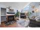 Cozy living room featuring a fireplace, large windows, and stylish decor at 4086 S Carson St # F, Aurora, CO 80014