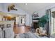 Open concept living space with fireplace, tile floors, and a view into the kitchen at 4086 S Carson St # F, Aurora, CO 80014