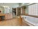Luxurious bathroom featuring a glass shower, tub, double sink and walk-in closet at 7869 Solstice Way, Castle Rock, CO 80108