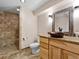 Elegant bathroom featuring a tiled shower, unique copper sink, and stylish vanity at 7869 Solstice Way, Castle Rock, CO 80108