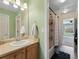 Well-lit bathroom featuring a shower over tub, vanity with sink and neutral paint at 7869 Solstice Way, Castle Rock, CO 80108