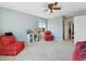 Spacious bedroom featuring a ceiling fan, neutral carpet, a window and red chairs at 7869 Solstice Way, Castle Rock, CO 80108