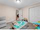 Bedroom with light-colored walls, closet, and gray couch at 7869 Solstice Way, Castle Rock, CO 80108