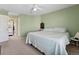 Spacious bedroom featuring a ceiling fan, neutral carpet, and access to the bathroom at 7869 Solstice Way, Castle Rock, CO 80108