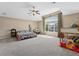 Bright bedroom featuring a large window, ceiling fan, neutral carpet and space at 7869 Solstice Way, Castle Rock, CO 80108