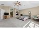Large bedroom featuring a fireplace, ceiling fan, and plenty of space at 7869 Solstice Way, Castle Rock, CO 80108
