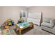 Bedroom features a play table, gray couch, and light-colored walls at 7869 Solstice Way, Castle Rock, CO 80108