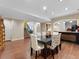 Charming dining area with hardwood floors, modern lighting, and seating for six at 7869 Solstice Way, Castle Rock, CO 80108