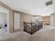 Upstairs hallway featuring carpet, a railing overlooking the downstairs, and neutral paint at 7869 Solstice Way, Castle Rock, CO 80108