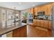 Bright kitchen featuring stainless steel appliances, granite countertops, and wood cabinets at 7869 Solstice Way, Castle Rock, CO 80108