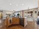 Open-concept kitchen boasts granite countertops and seamlessly connects to the living area with a cozy fireplace at 7869 Solstice Way, Castle Rock, CO 80108
