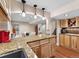 Well-appointed kitchen with granite countertops, wooden cabinets, and stainless steel sink at 7869 Solstice Way, Castle Rock, CO 80108