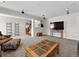 Inviting living area featuring cozy seating, a stylish coffee table, and sleek lighting at 7869 Solstice Way, Castle Rock, CO 80108