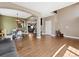 Open-concept living area with hardwood floors, archways, and a view of the staircase at 7869 Solstice Way, Castle Rock, CO 80108