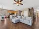 Open-concept living space with a modern kitchen, comfortable seating, and staircase at 7869 Solstice Way, Castle Rock, CO 80108