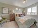 Cozy bedroom featuring large windows, stylish decor and a plush, comfortable bed at 10366 Uvalda Ct, Commerce City, CO 80022