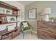 Cozy, well-decorated flex room with modern shelving, a cushioned chair, and soft carpet at 10366 Uvalda Ct, Commerce City, CO 80022