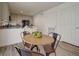Dining area with seating for four offers modern décor, bar stools, and opens to a kitchen with ample storage at 10366 Uvalda Ct, Commerce City, CO 80022
