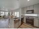 Bright kitchen features shaker cabinets, stainless steel appliances, granite countertops, and opens to the sunny living room at 10366 Uvalda Ct, Commerce City, CO 80022