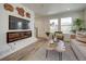 Inviting living room features a modern fireplace, comfortable seating, lots of natural light, and an open floor plan at 10366 Uvalda Ct, Commerce City, CO 80022