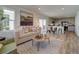Bright, open-concept living area with a comfortable sofa, unique wood coffee table, and access to a modern kitchen at 10366 Uvalda Ct, Commerce City, CO 80022