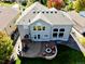 Aerial view of home showcasing backyard fire pit, seating, and manicured lawn at 23029 Cleveland Dr, Parker, CO 80138
