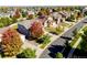An aerial view shows homes with mature trees and solar panels on one of the homes in the neighborhood at 23029 Cleveland Dr, Parker, CO 80138