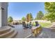 Inviting backyard patio with ample seating, a built-in grill, and manicured landscaping at 23029 Cleveland Dr, Parker, CO 80138