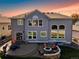Beautiful backyard with a stone patio, fire pit, and seating area for outdoor entertaining at 23029 Cleveland Dr, Parker, CO 80138