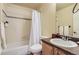 Cozy bathroom with tub and shower combo, tile surround, and wood vanity at 23029 Cleveland Dr, Parker, CO 80138