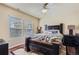 Bedroom with wood floors, ceiling fan, a window for natural light, and a dark furniture set at 23029 Cleveland Dr, Parker, CO 80138