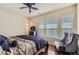 Comfortable bedroom features a ceiling fan, hardwood floors, and a stylish accent chair at 23029 Cleveland Dr, Parker, CO 80138
