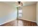 Simple bedroom with a ceiling fan, hardwood floors, and a window overlooking the street at 23029 Cleveland Dr, Parker, CO 80138