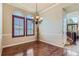 Bright dining room with hardwood floors, elegant lighting, and large windows at 23029 Cleveland Dr, Parker, CO 80138