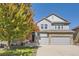 Charming two-story home featuring a two-car garage, stone accents, and inviting curb appeal at 23029 Cleveland Dr, Parker, CO 80138