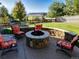 A fire pit surrounded by Adirondack chairs invites outdoor gatherings and cozy evenings in the landscaped backyard at 23029 Cleveland Dr, Parker, CO 80138