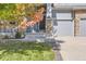 Inviting front entrance with stone accents, landscaped yard, and a welcoming porch at 23029 Cleveland Dr, Parker, CO 80138