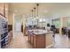 Open kitchen layout with center island, stainless appliances, breakfast area, and seamless flow to the living spaces at 23029 Cleveland Dr, Parker, CO 80138